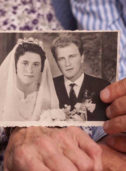 couple holding old wedding picture