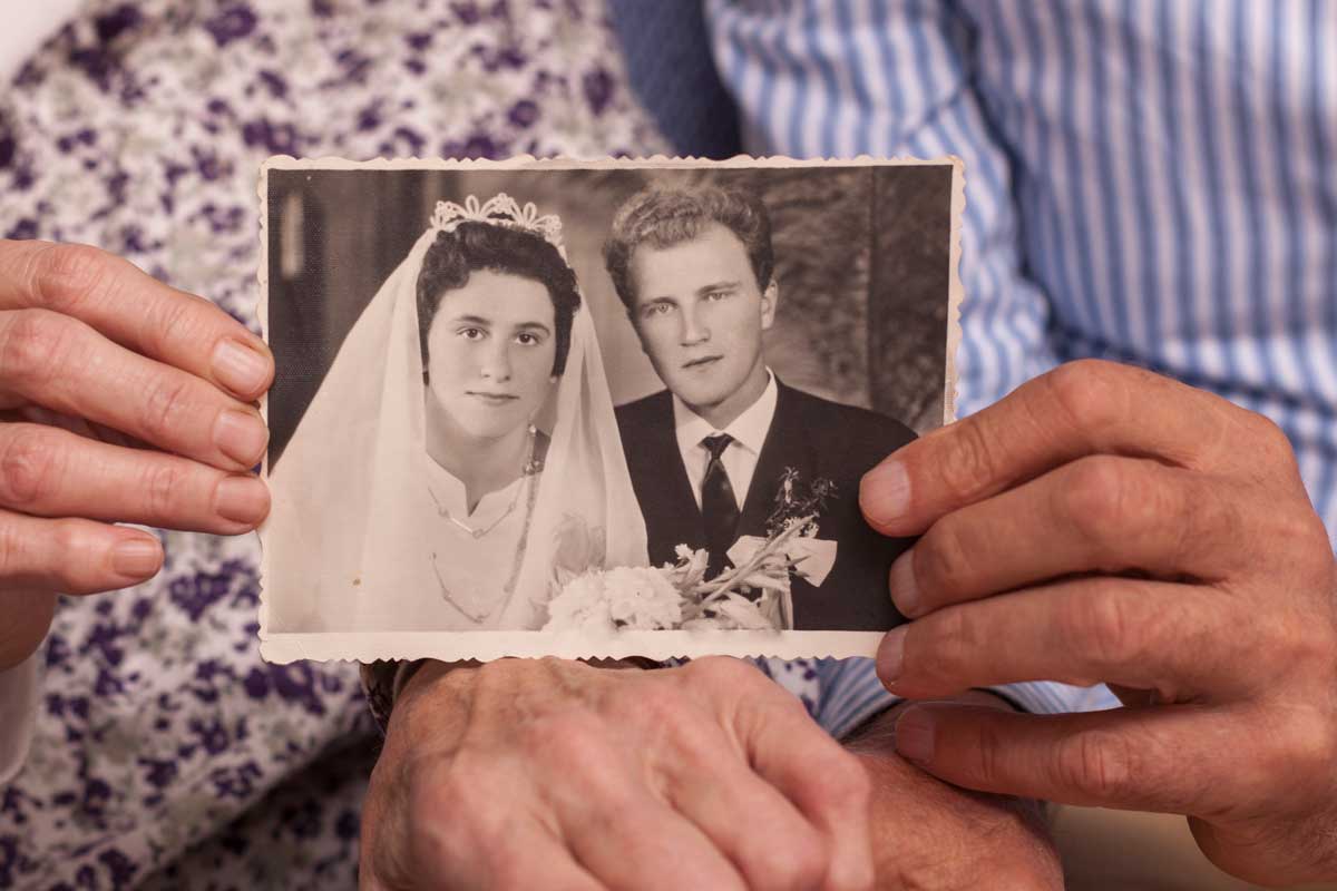 couple holding old wedding picture